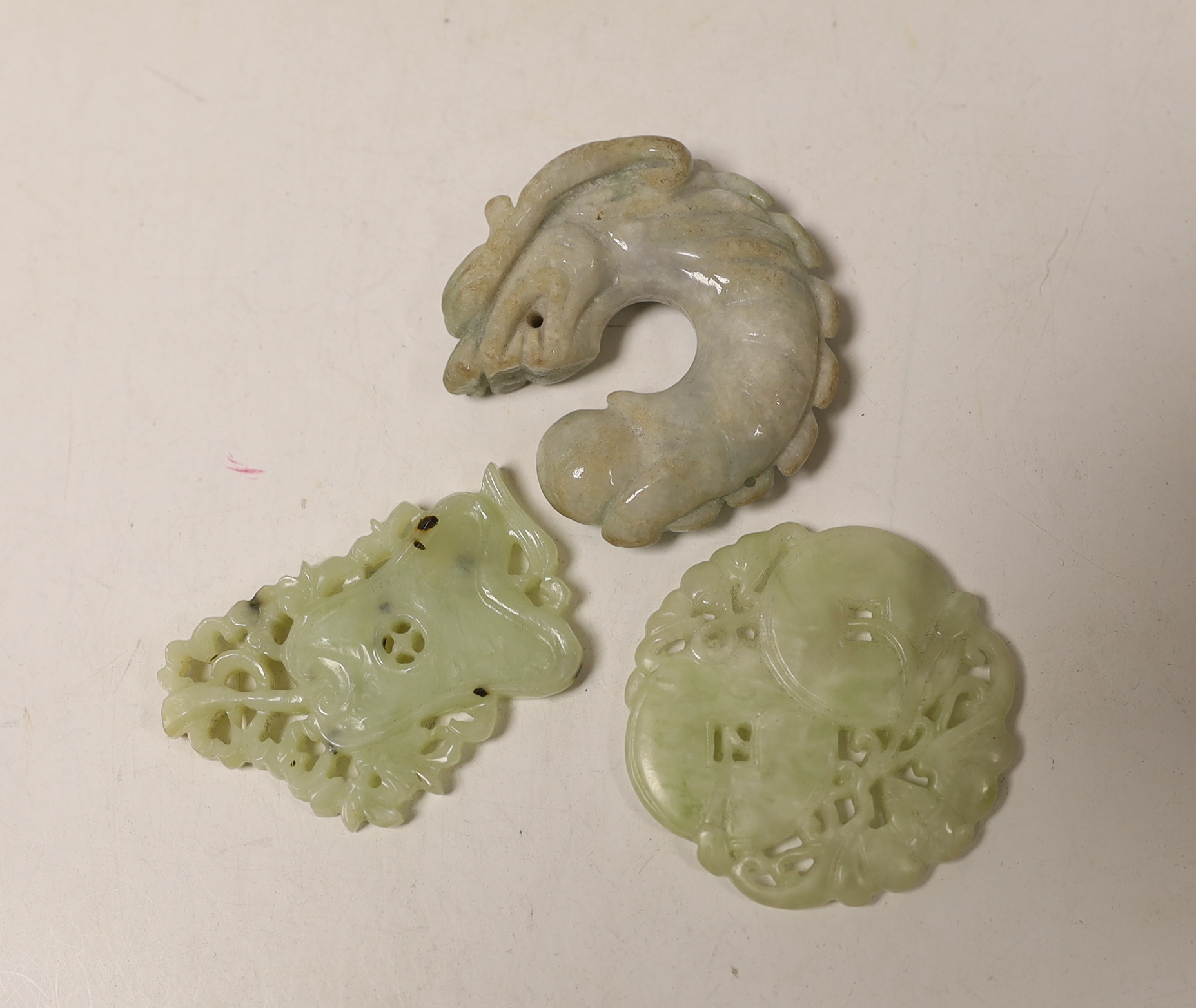 A Chinese white jade pendant plaque and three jadeite pendants, largest 7cm